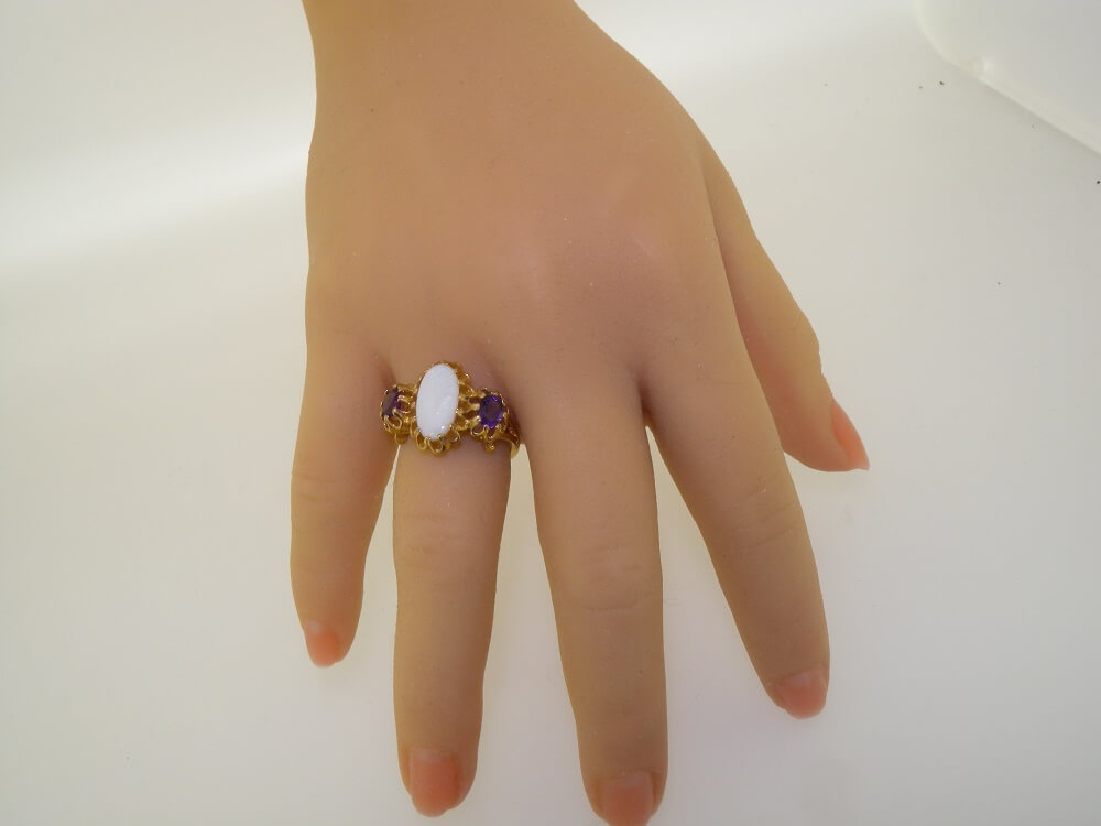 2264.4aaa.1 on hand ornate gold opal and amethyst trilogy ring on hand