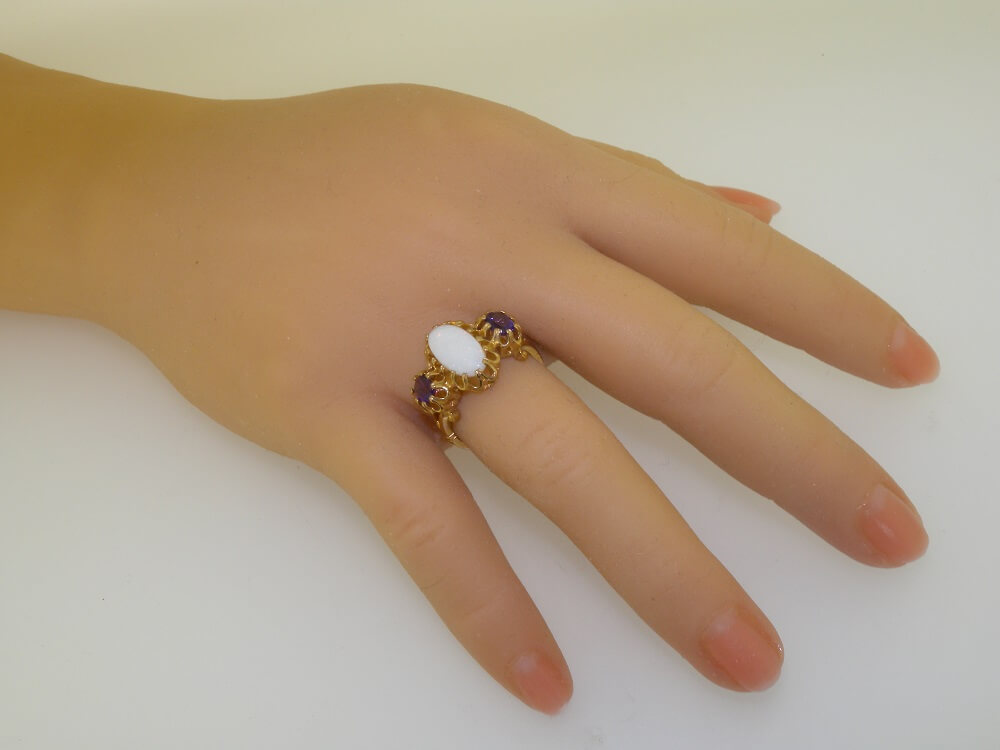 2264.4aaa.1 on hand_2 oval opal and amethyst trilogy ring on hand