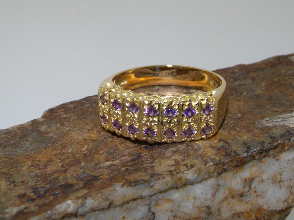 2612.1.18Y_1 gold amethyst eternity ring on rock