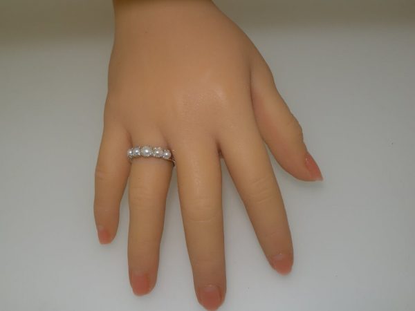 gold eternity ring set with pearls on hand